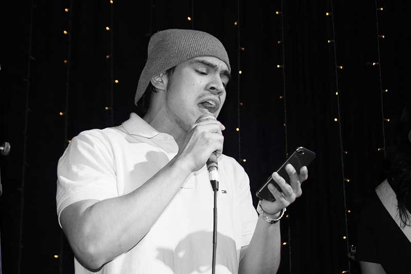 Adult vocal student singing on stage