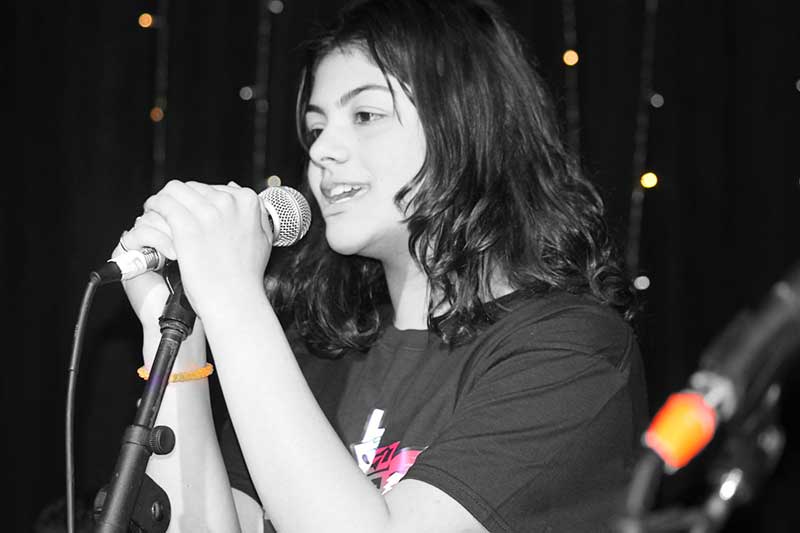 Vocal student singing on stage